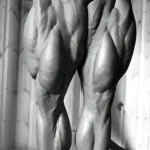 Arnold Schwarzenegger demonstrating leg extension for quad growth